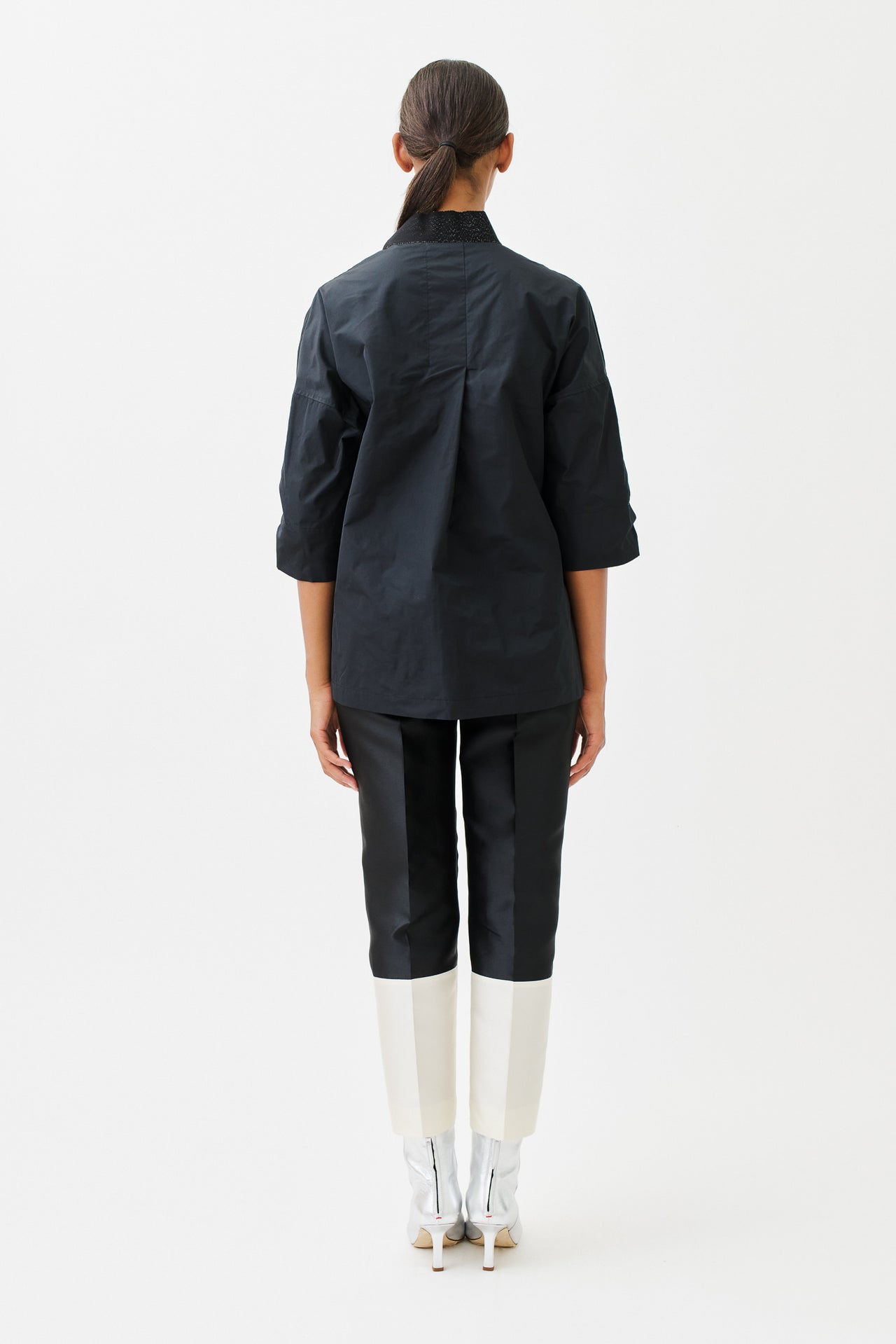 wingate collection tayne black top on female model with silver slippers back