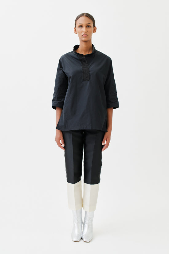 wingate collection tayne black top on female model with silver slippers front