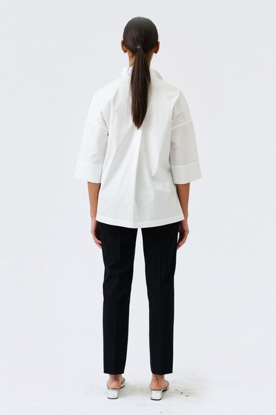 wingate collection tayne white top on female model with silver slippers back