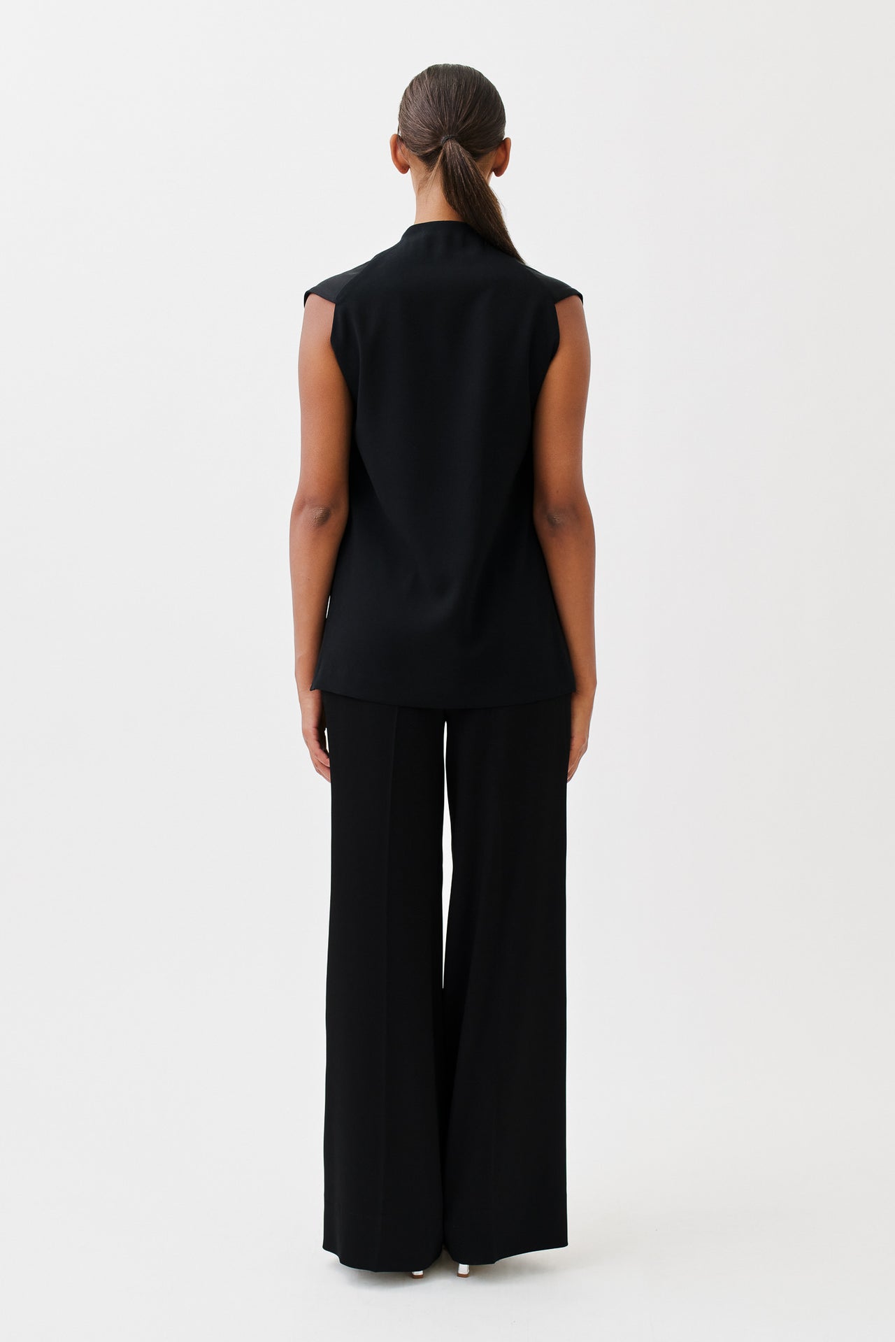 wingate collection taru black top on female model with silver boots back