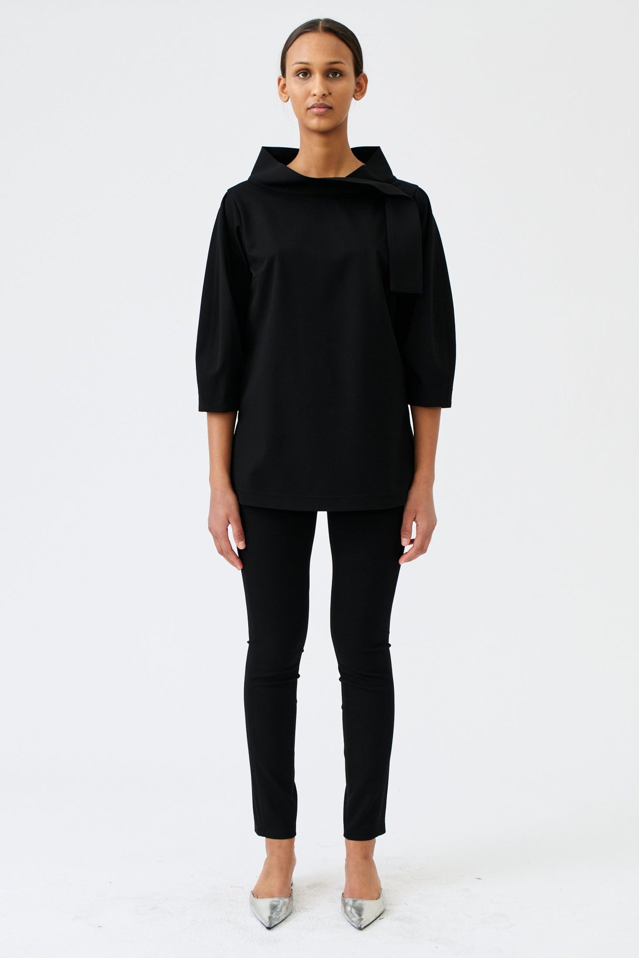 wingate collection teno black top on female model with silver slippers front