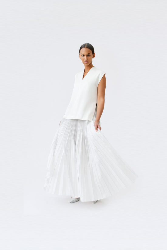 wingate collection taru white top on female model with silver slippers dynamic