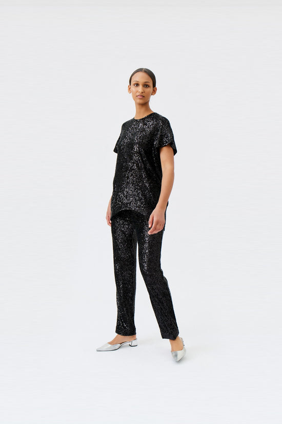 wingate collection tia black top on female model with silver slippers dynamic